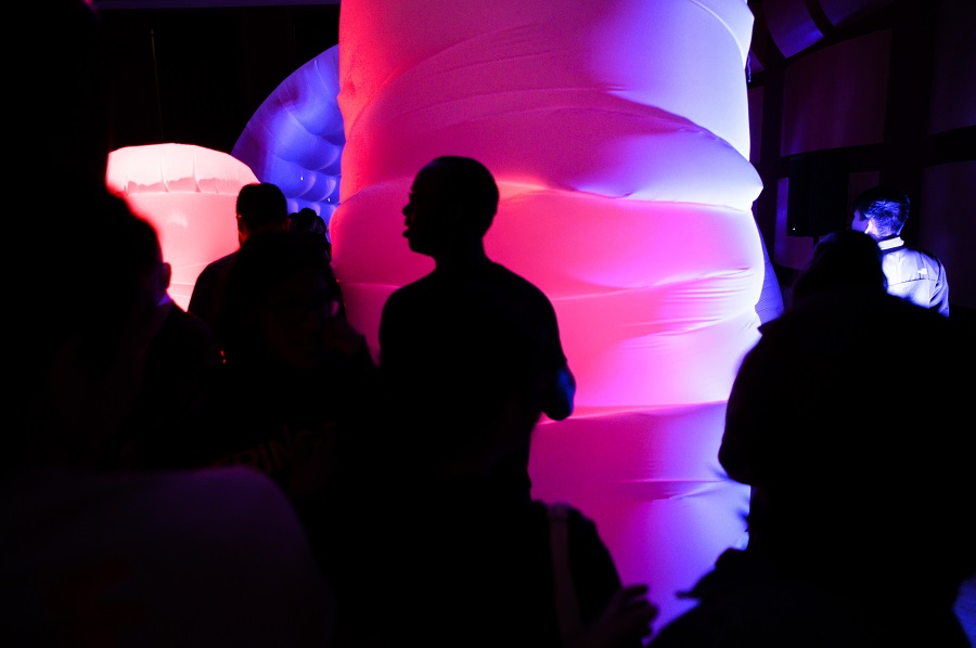 Attendees at an event in front of an inflatable sculpture