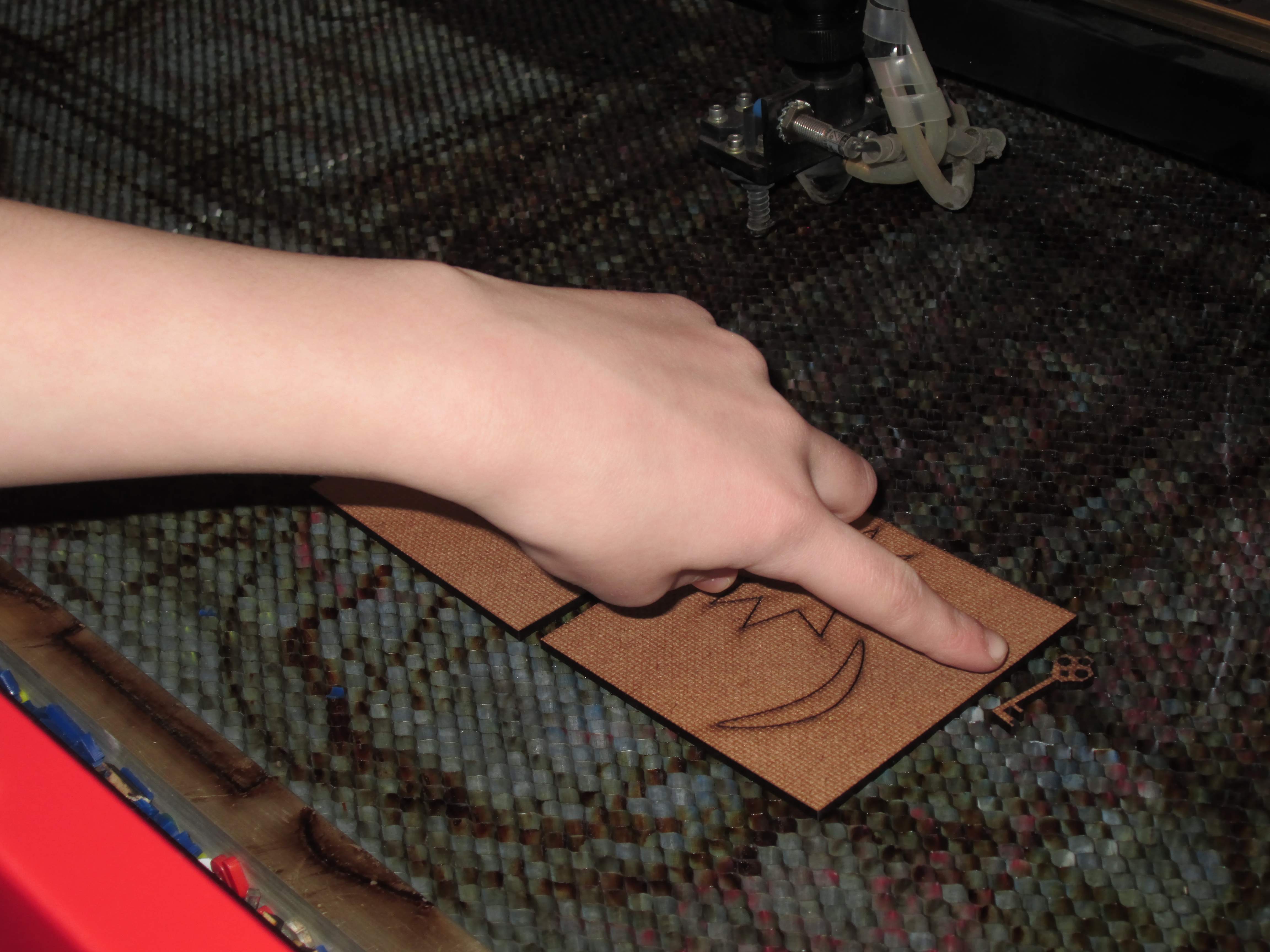 Student learning to use laser cutter
