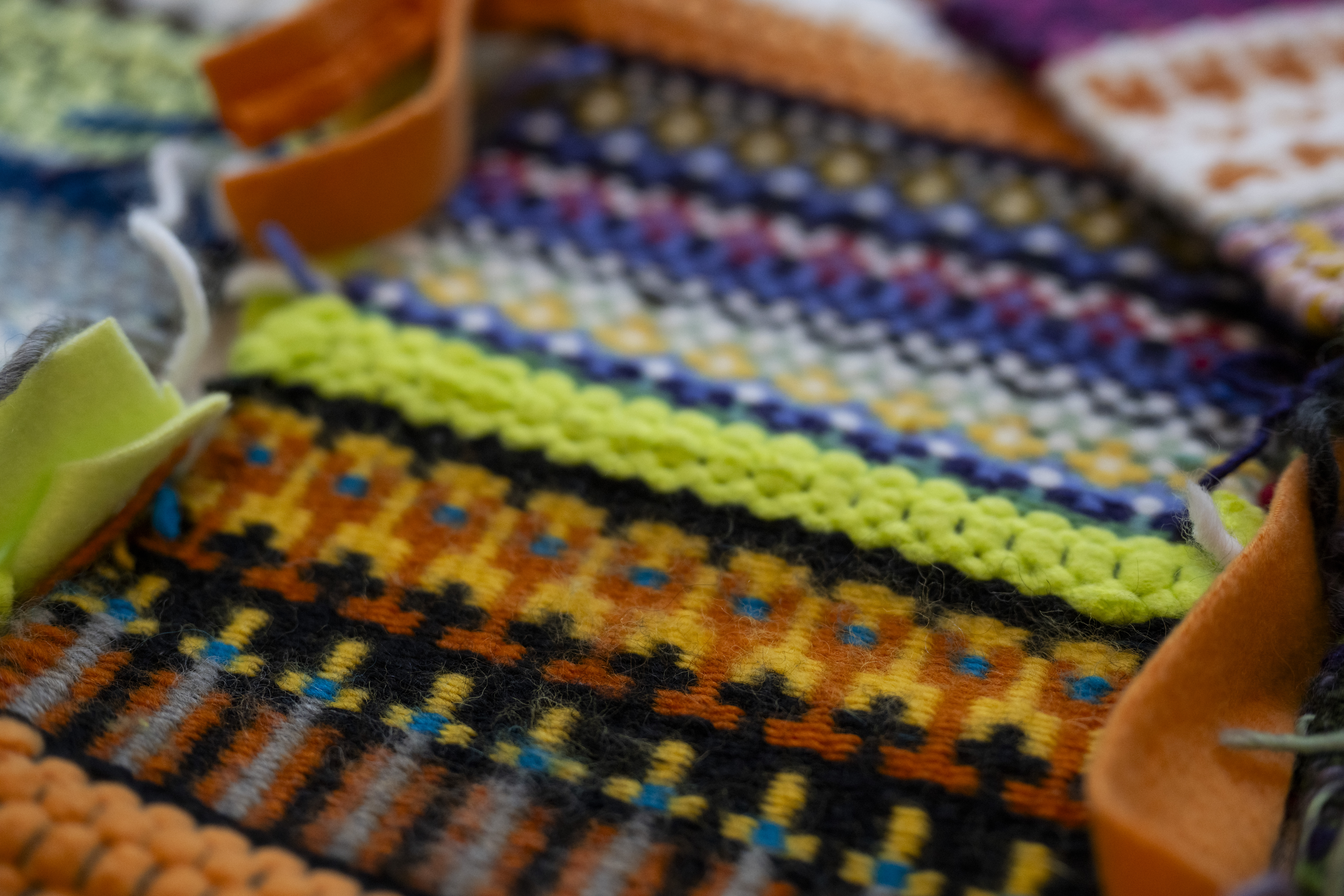 a close up of weaving with blue and orange thread