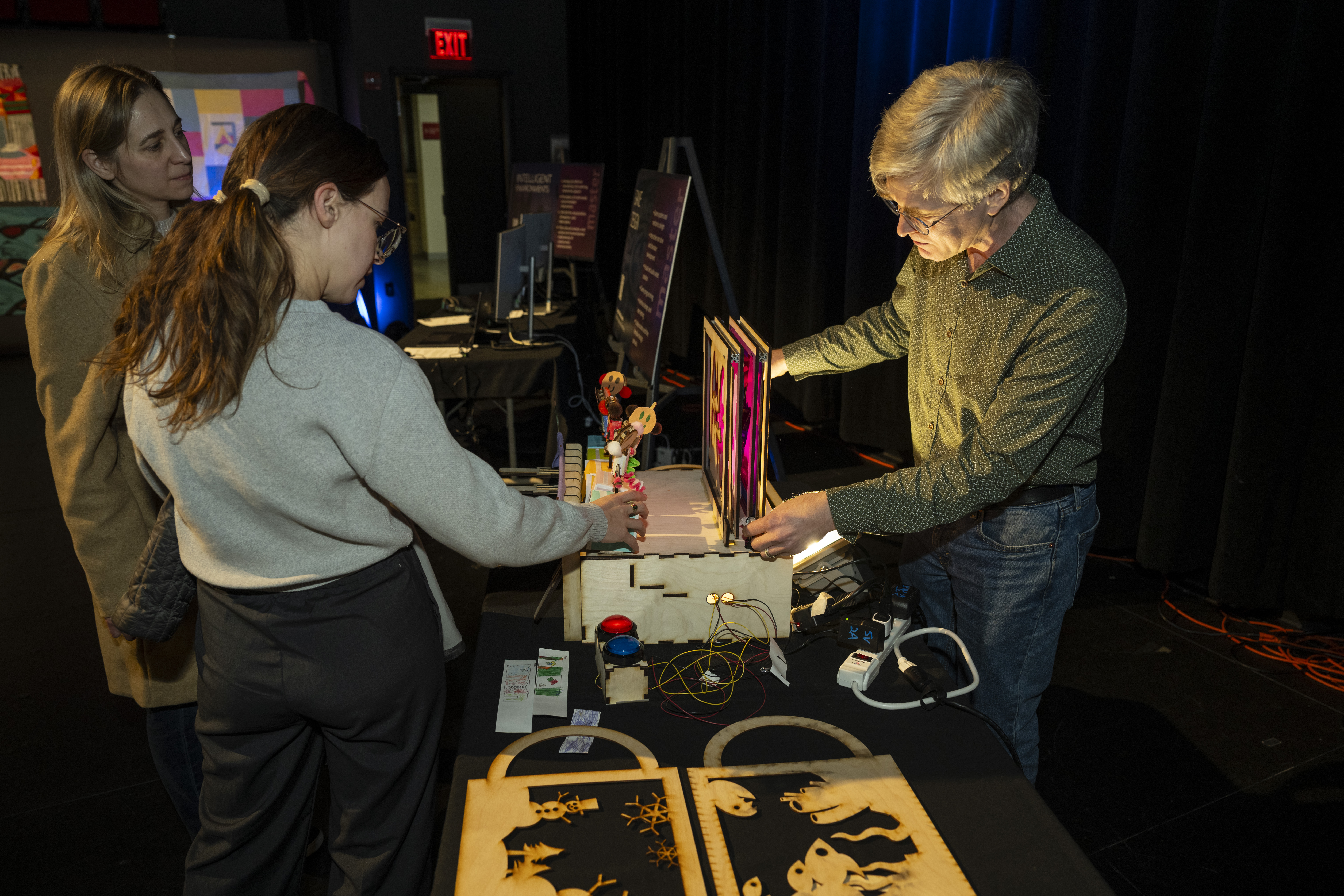 instructor introduces attendees to the robot puppet theatre designed for younger children