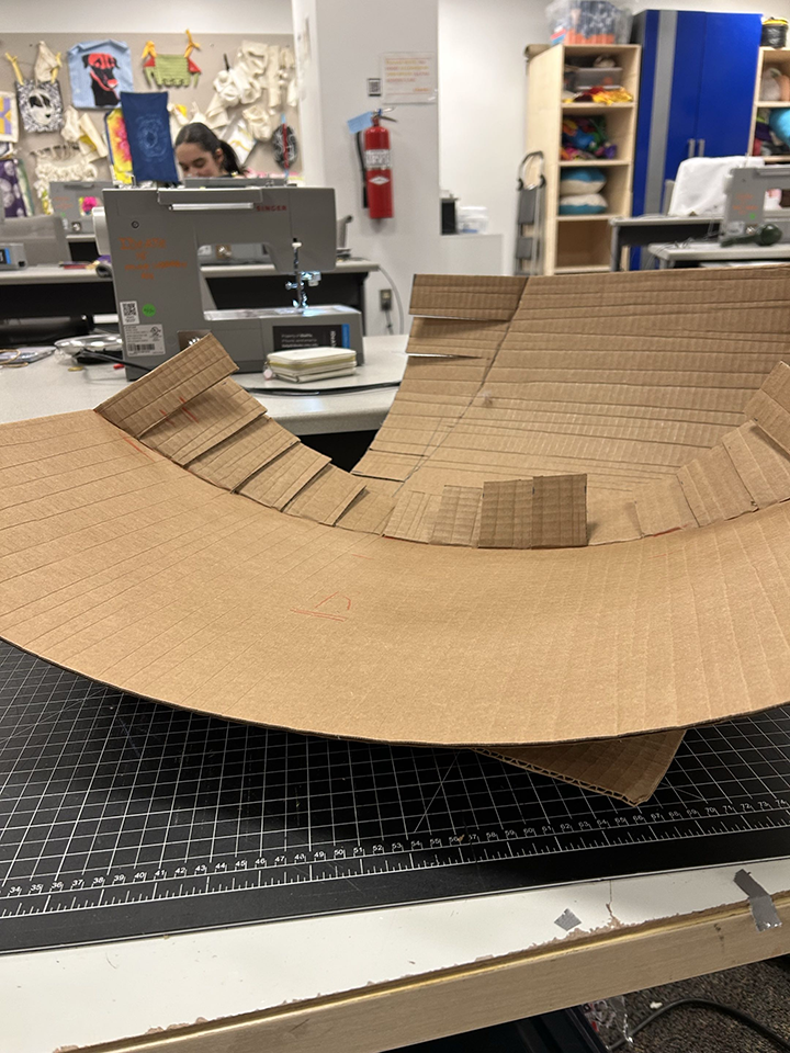 a rolled piece of cardboard with slits cut for easy shaping
